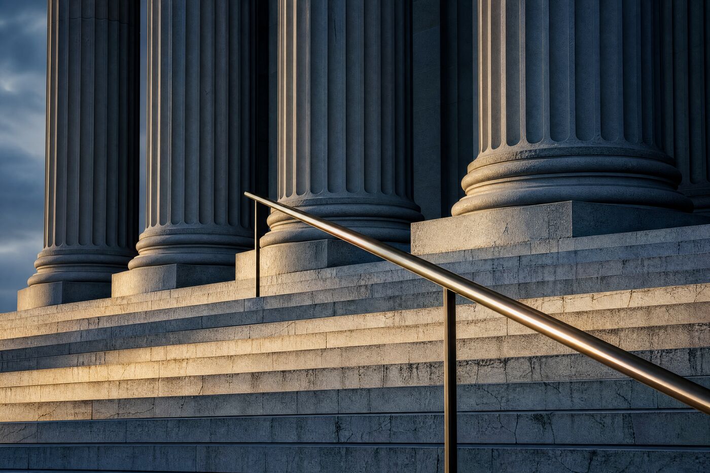 The stone steps and columns of a county courthouse in low morning sun.